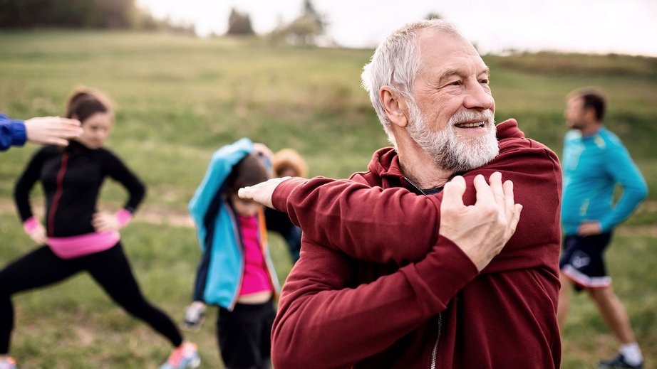 Person walking on a quiet street with trees in the background